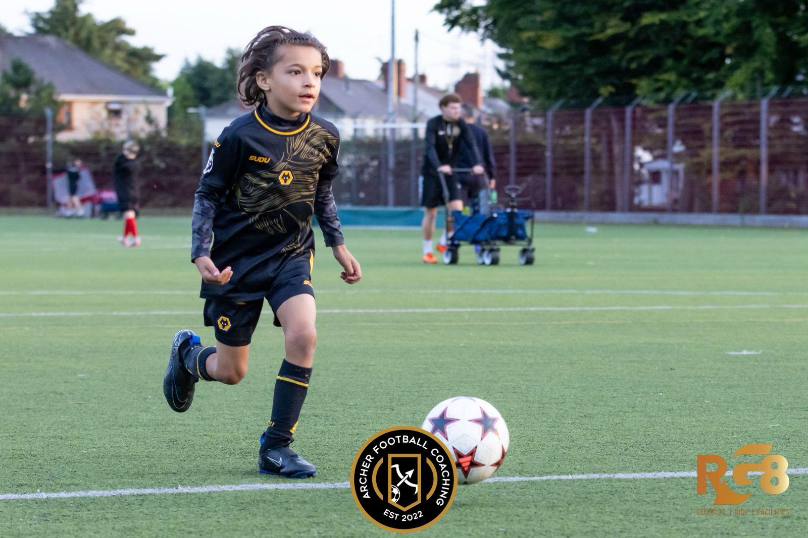 Xander running with the ball under floodlights
