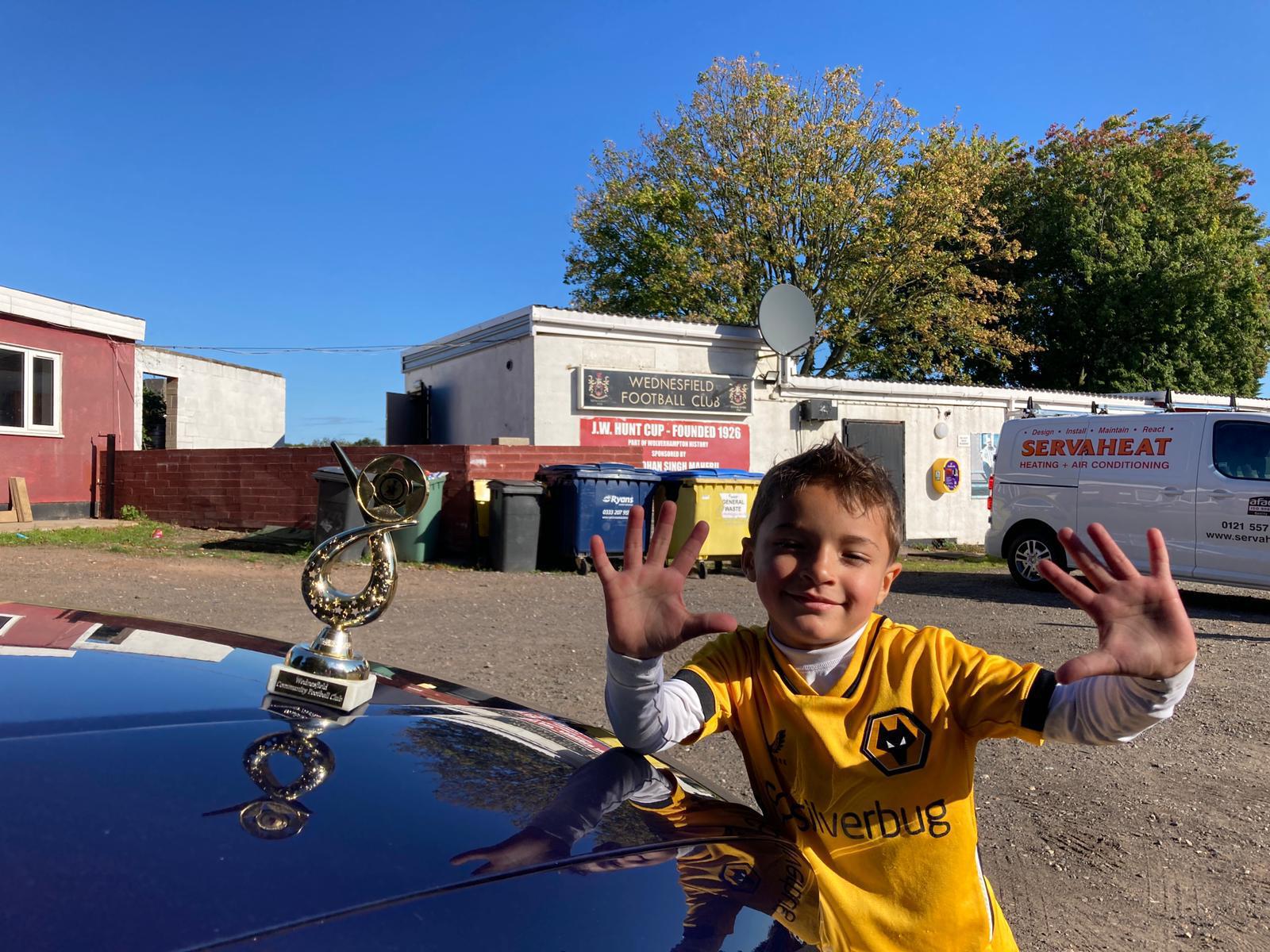 Xander celebrating with a trophy
